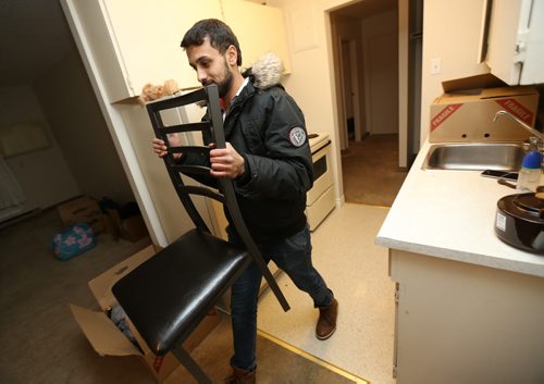 Ahmed Mohmoud, a Syrian refugee, unloading furniture with the help of Nadia Ourrhi and Abdul Absuleh, from Welcome Place, Friday, January 22, 2016. (TREVOR HAGAN/WINNIPEG FREE PRESS)