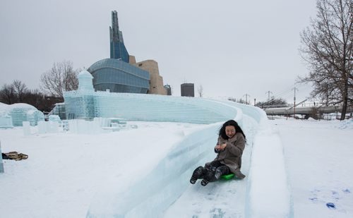 Workers continue to put the finishing touches on the Great Ice Show at The Forks Sunday before the area opens to the public on Monday. Jane Yin from Jilin province, China, takes an opportunity to "test" one of the slides Sunday afternoon while everyone was taking a lunch break. 160124 - Sunday, January 24, 2016 -  MIKE DEAL / WINNIPEG FREE PRESS