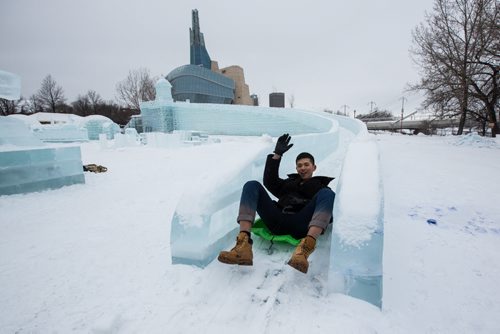 Workers continue to put the finishing touches on the Great Ice Show at The Forks Sunday before the area opens to the public on Monday. Carson Qian from Shanghai, China, takes an opportunity to "test" one of the slides Sunday afternoon while everyone was taking a lunch break. 160124 - Sunday, January 24, 2016 -  MIKE DEAL / WINNIPEG FREE PRESS