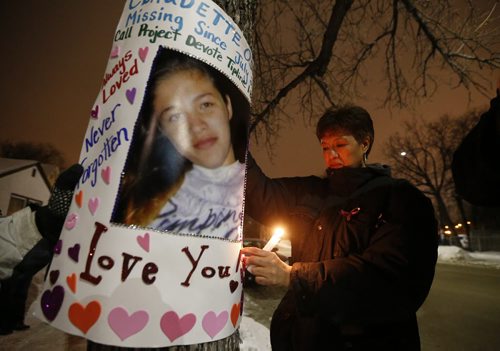 January 24, 2016 - 160124  -  Brenda Osbourne (R), mother of missing woman Claudette Osborne, hangs a poster of her daughter as family and friends joined her for a vigil Sunday, January 24, 2016. Family and friends gathered on Selkirk at King St the last possible location Claudette Osborne was seen July 2008. John Woods / Winnipeg Free Press