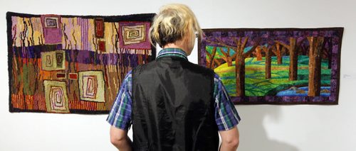 WINNIPEG, MB - ART STANDUP - Michael Joyal checked out some of the crafty art that is showing in the Cre8ery Gallery & Studios. (left) Sharon Loeppky's Hill with Fields (2015) wool on burlap backing hooked rug and (right) Lois Hogg's Into the Woods (2015)  fabric. For the Love of Craft. Manitoba Arts Council. BORIS MINKEVICH / WINNIPEG FREE PRESS January 26, 2016