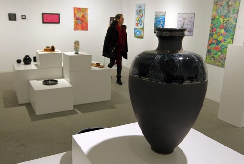 WINNIPEG, MB - ART STANDUP - An unidentified visitor checked out some of the crafty art that is showing in the Cre8ery Gallery & Studios. The porcelain vase made by artist Valorie Metcalfe is selling for $1100. For the Love of Craft. Manitoba Arts Council. BORIS MINKEVICH / WINNIPEG FREE PRESS January 26, 2016