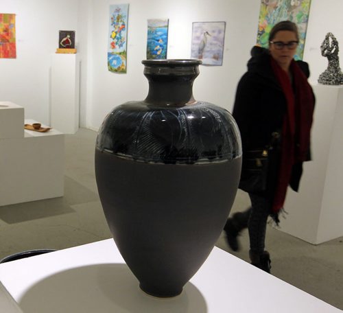 WINNIPEG, MB - ART STANDUP - An unidentified visitor checked out some of the crafty art that is showing in the Cre8ery Gallery & Studios. The porcelain vase made by artist Valorie Metcalfe is selling for $1100. For the Love of Craft. Manitoba Arts Council. BORIS MINKEVICH / WINNIPEG FREE PRESS January 26, 2016