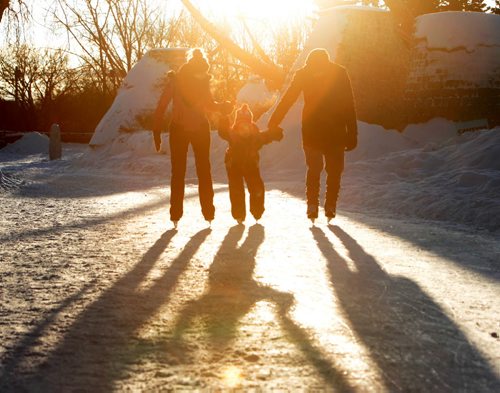 Six-year-old  Layla Scharf gets pulled along the skating path at the Forks  by her mom, Allison, and friend  while learning to skate as the sun sets behind them creating long shadows and silhouette's Tuesday afternoon.   Jan 26, 2016 Ruth Bonneville / Winnipeg Free Press