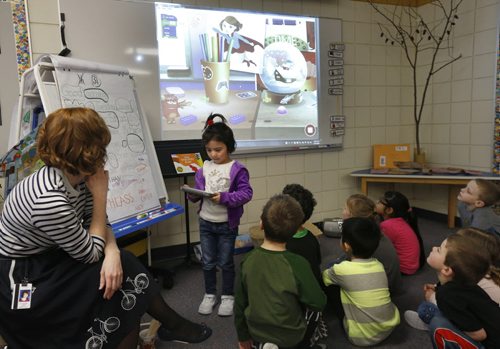 At left, teacher Meagan Chopek with students learning about computer coding in the kindergarten class in Island Lakes Community School. Student Ekhlass with IPad taking her turn on the Tynker coding game projected behind her. Nick Martin story Wayne Glowacki / Winnipeg Free Press Jan. 26 2016