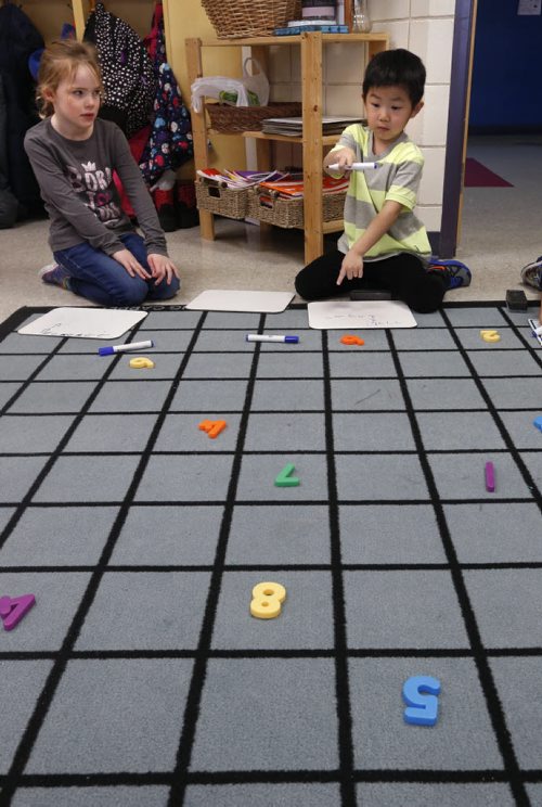 Sophie watches Cayden plan out his move counting spaces on the "learning carpet" and recording it on his board. This game is part of the computer coding exercises they are  learning in their kindergarten class in Island Lakes Community School.  Nick Martin story Wayne Glowacki / Winnipeg Free Press Jan. 26 2016