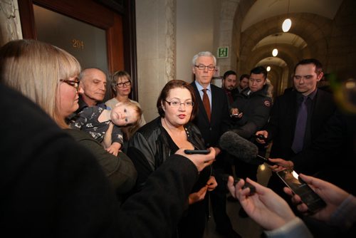 Fort Rouge MLA Jennifer Howard answers questions from the media while her  8-month-old daughter, Georgia, held by Howard's wife, Tara Peel, leans into her during press conference announcing her not seeking re-election and departure from the NDP party at the Leg Wednesday afternoon.   Jan 27, 2016 Ruth Bonneville / Winnipeg Free Press