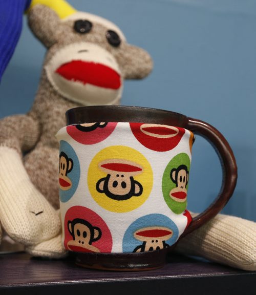 49.8/Intersection.  Sharon Forzley has been making hand-sewn sock monkeys for about six years - no two the same - and she's going retail for the 1st time, at A Pinch of Creativity, a new shop featuring made-in-Manitoba products on McDermot Ave. This is a monkey cup cosy. David Sanderson story Wayne Glowacki / Winnipeg Free Press Jan. 27 2016