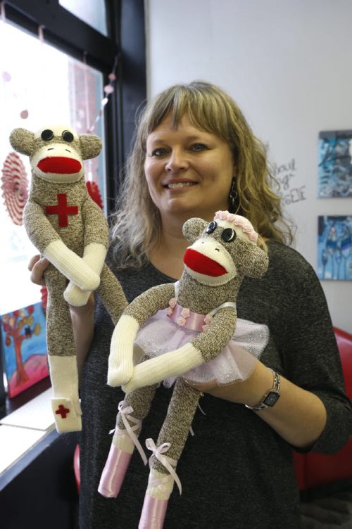 49.8/Intersection.  Sharon Forzley has been making hand-sewn sock monkeys for about six years - no two the same - and she's going retail for the 1st time, at A Pinch of Creativity, a new shop featuring made-in-Manitoba products on McDermot Ave. She is holding Medical Monkey and Ballerina Monkey. David Sanderson story Wayne Glowacki / Winnipeg Free Press Jan. 27 2016