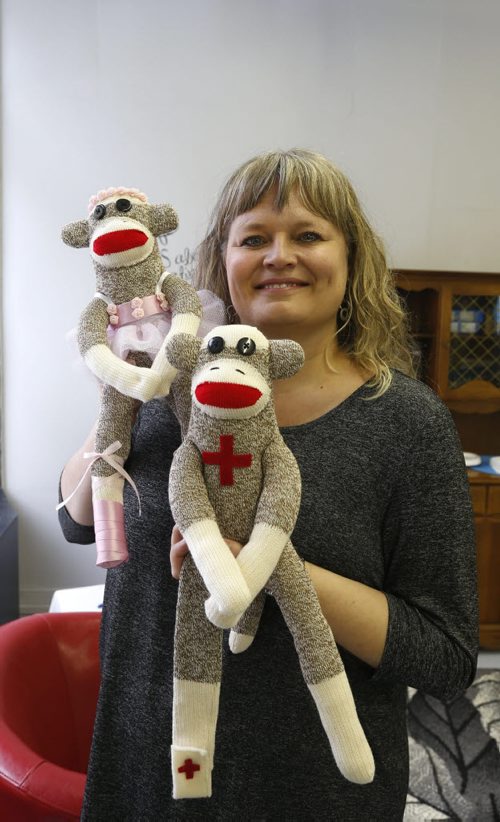 49.8/Intersection.  Sharon Forzley has been making hand-sewn sock monkeys for about six years - no two the same - and she's going retail for the 1st time, at A Pinch of Creativity, a new shop featuring made-in-Manitoba products on McDermot Ave. She is holding Medical Monkey and Ballerina Monkey. David Sanderson story Wayne Glowacki / Winnipeg Free Press Jan. 27 2016
