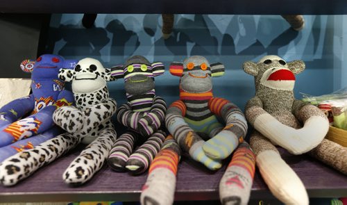 49.8/Intersection.  Sharon Forzley has been making hand-sewn sock monkeys for about six years - no two the same - and she's going retail for the 1st time, at A Pinch of Creativity, a new shop featuring made-in-Manitoba products on McDermot Ave. A row of seated Monkeys. David Sanderson story Wayne Glowacki / Winnipeg Free Press Jan. 27 2016