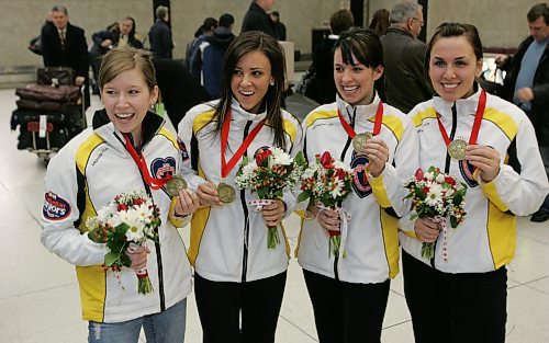 BORIS MINKEVICH / WINNIPEG FREE PRESS  080211 Manitoba Jr. Womens curling team l-r Skip Kaitlyn Lawes, third Jenna Loder, second Liz Peters and lead Sarah Wazney. They posed for a photo after arriving in Winnipeg from the women's Canadian junior curling championships, which they won.