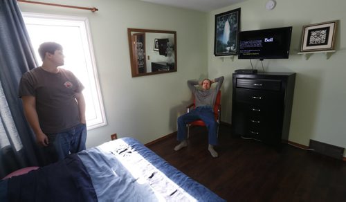Bert Gockel sits in a chair in his bedroom with Residential Treatment Worker Richard Guenter  in the New Directions home in the RM of Springfield where 3 intellectually disabled men live. Carol Sanders story Wayne Glowacki / Winnipeg Free Press Jan. 28 2016