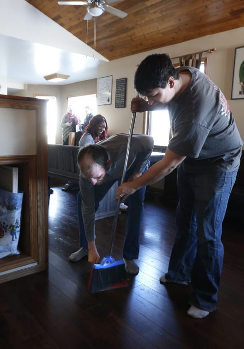 At left, Bert Gockel holds the dust pan for Residential Treatment Worker Richard Guenter  in the New Directions home in the RM of Springfield where 3 intellectually disabled men live. Carol Sanders story Wayne Glowacki / Winnipeg Free Press Jan. 28 2016