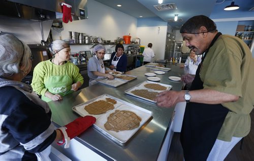 At right, Marcel Sanderson looks at the crackers made with spelt flour that just came out of the oven. He is taking a sour dough workshop taught by traditional food teacher Wendy Erlanger at the NorWest Co-op Community Food Centre. The story is about healthy eating and access to food along with soaring rates of diabetes.  Kristin Annable story Wayne Glowacki / Winnipeg Free Press Jan. 28 2016
