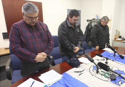 L to R - Chief David McDougall from St Theresa Point, Peter Harper from Red Sucker Lake, and Chief Arnold Flett from Garden Hill First Nation say a prayer prior to news conference discussing how Perimeter Airlines  sent wrong casket on a return flight home last Saturday to Red Sucker Lake . -See Alexander Paul story- Jan 29, 2016   (JOE BRYKSA / WINNIPEG FREE PRESS