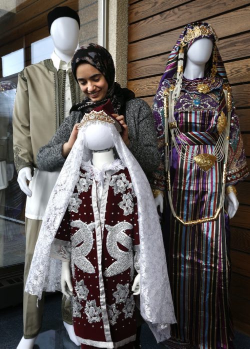 Heba Elgubtan by the traditional Libyan clothing display being set up Tuesday in preparation for the Arab Cultural Exhibition on Wed. Feb 3 from 9:30 to 3 pm at the Marshall McLuhan Hall in the U of M  University Centre. There will be Arabic calligraphers, Arabian horse experts, an Arab artist from Morocco and local Arab speakers from Syria and Palestine.Carol Sanders story Wayne Glowacki / Winnipeg Free Press Feb.2 2016