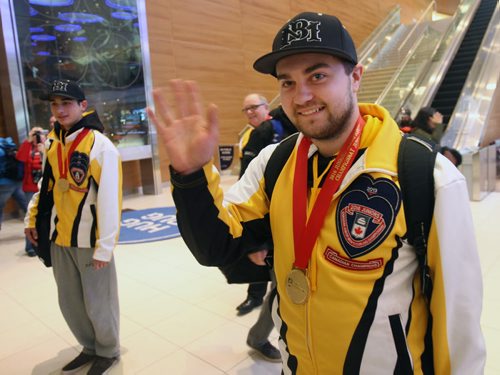 Skip Matt Dunstonewaves to the crowd as he and his team arrive at James A International airport in Winnipeg Monday after returning home with the Canadian Jr Curling Championship they won in Stratford -Melissa Martin story- Feb 01, 2016   (JOE BRYKSA / WINNIPEG FREE PRESS)