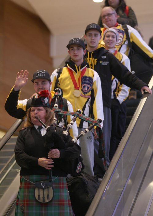 Skip Matt Dunstonewaves to the crowd as he and his team arrive at James A International airport in Winnipeg Monday after returning home with the Canadian Jr Curling Championship they won in Stratford -Melissa Martin story- Feb 01, 2016   (JOE BRYKSA / WINNIPEG FREE PRESS)
