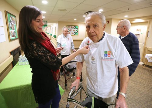 All Seniors Care Seniors games assistant John Junson gets a sticker for completing a walking lap from Amy Wolfe, education and community engagement co-ordinator for the Winnipeg Symphony Orchestra, at Sturgeon Creek Retirement Residence on Feb. 1, 2016. Photo by Jason Halstead/Winnipeg Free Press RE: Social Page