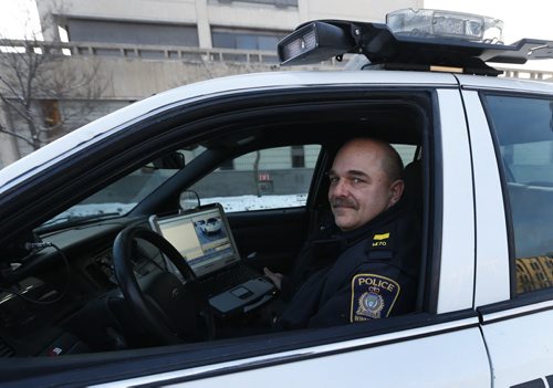 Winnipeg Police Service Patrol Sgt. Lou Malo, Central Traffic Enforcement Co-ordinator in a police car with automated  licence plate reading equipment. Above his head on the roof is one of three cameras that simultaneously scan licence plates of vehicles. Winnipeg Police Service uses licence-plate scanning technology to find stolen cars and drivers with suspended licences or other infractions. Its the same technology that makes MPIs licence-renewal decals obsolete.  The officer is alerted on the computer screen when a flagged vehicle is found. Katie May story Wayne Glowacki / Winnipeg Free Press Feb.4 2016