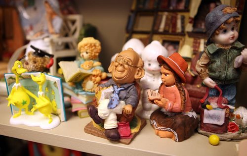 Providence University College, Otterburne, Mb. - Terry Kennedy, library director at Providence College has her office full of reading figurines. This is for an I Love to Read Month collectibles story - Feb. is I Love to Read Month and I'm profiling a few book-related collections - feature story will be Terry's collection of reading figurines. In her office at the library, she has bookshelves overflowing with 100s of figurines, ornaments and statuettes - all of which are reading a book or newspaper. In photo are a selection of some of her favourites.  BORIS MINKEVICH / WINNIPEG FREE PRESS February 4, 2016