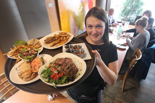 In Fernos Bistro- 312 Des Meurons St- Server Celeste Theriault passes by with orders-See David Sanderson This City Feature  Feb 04, 2016   (JOE BRYKSA / WINNIPEG FREE PRESS)