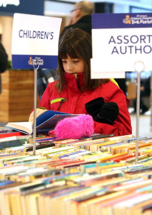 Megan Kopytko,8, enjoys her day off school with her dad picking some books out at the mall. --What do 400 year-round volunteers, books as far as the eye can see, helping sick children and raising over $8 million in 56 years have in common? The February sale of the Childrens Hospital Book Market kicks of tomorrow, Thursday February 4th at St. Vital Centre. Over 65 categories from fiction, science, childrens and more are up for unbelievable deals. Our volunteers work tirelessly knowing that they are making a difference in the lives of sick and injured children, states Carol Irving, Childrens Hospital Book Market Coordinator. Support of the Childrens Hospital Book Market allows for programs like the Book Corner, CHTV  the internal Childrens Hospital commercial free television station and the Family Resource library to continue for many years to come.  From Thursday, February 4th to Saturday, February 6th, The Childrens Hospital Book Market will have tables stacked with books ready for sale at St. Vital Centre. Volunteers have sorted each book  s?ports books, personal development, recent university texts, biographies, mystery, young adult and cookbooks are just some of the 65 categories available. E?ach book sold helps the Childrens Hospital Book Market meet their goal of raising $500,000 through book sales this year. Come out and help them reach their goal! Community assistance is crucial for ensuring our children get the best care possible for a brighter future, states Lawrence Prout, President & CEO, Childrens Hospital Foundation of Manitoba. By coming to St. Vital Centre and purchasing a book, you are contributing to these important support services that will bring comfort to sick children and their families during difficult times. The Book Market is open during regular St. Vital Centre hours. For more information visit stvitalcentre.com or goodbear.mb.ca.  BORIS MINKEVICH / WINNIPEG FREE PRESS February 4, 2016