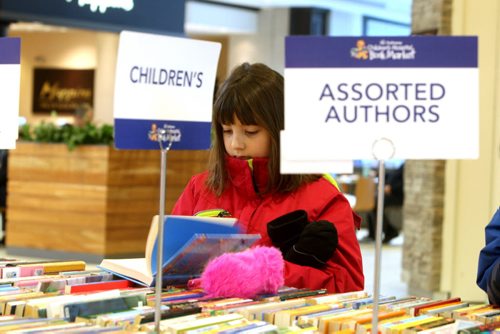 Megan Kopytko,8, enjoys her day off school with her dad picking some books out at the mall. --What do 400 year-round volunteers, books as far as the eye can see, helping sick children and raising over $8 million in 56 years have in common? The February sale of the Childrens Hospital Book Market kicks of tomorrow, Thursday February 4th at St. Vital Centre. Over 65 categories from fiction, science, childrens and more are up for unbelievable deals. Our volunteers work tirelessly knowing that they are making a difference in the lives of sick and injured children, states Carol Irving, Childrens Hospital Book Market Coordinator. Support of the Childrens Hospital Book Market allows for programs like the Book Corner, CHTV  the internal Childrens Hospital commercial free television station and the Family Resource library to continue for many years to come.  From Thursday, February 4th to Saturday, February 6th, The Childrens Hospital Book Market will have tables stacked with books ready for sale at St. Vital Centre. Volunteers have sorted each book  s?ports books, personal development, recent university texts, biographies, mystery, young adult and cookbooks are just some of the 65 categories available. E?ach book sold helps the Childrens Hospital Book Market meet their goal of raising $500,000 through book sales this year. Come out and help them reach their goal! Community assistance is crucial for ensuring our children get the best care possible for a brighter future, states Lawrence Prout, President & CEO, Childrens Hospital Foundation of Manitoba. By coming to St. Vital Centre and purchasing a book, you are contributing to these important support services that will bring comfort to sick children and their families during difficult times. The Book Market is open during regular St. Vital Centre hours. For more information visit stvitalcentre.com or goodbear.mb.ca.  BORIS MINKEVICH / WINNIPEG FREE PRESS February 4, 2016
