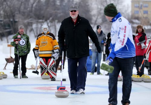 Doug Speirs participates in the media challenge prior to the Ironman Outdoor Curling Bonspiel as Colin Hodgson waits to sweep, at The Forks, Friday, February 5, 2016. (TREVOR HAGAN/WINNIPEG FREE PRESS)