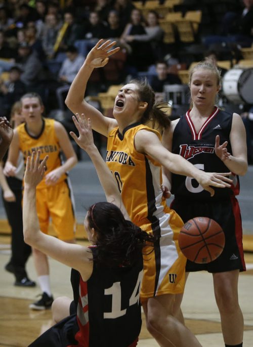 University of Manitoba Bisons player #10 Montana Kinzel grimaces as she gets the ball knocked out from her by Wesman #14Taylor Thorkelesson, during the 25th Annual Duckworth Challenge held at Investors Group Athletic Centre Friday night, Wesman went on to win the game against the Bisons 69 - 64. February 05, 2016 Ruth Bonneville / Winnipeg Free Press