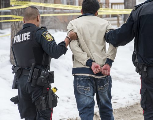 DAVID LIPNOWSKI / WINNIPEG FREE PRESS 160206  A man is taken into police custody after getting into an altercation at the scene of an unrelated crime Saturday February 6, 2015 in the 500 block of Stella Avenue.