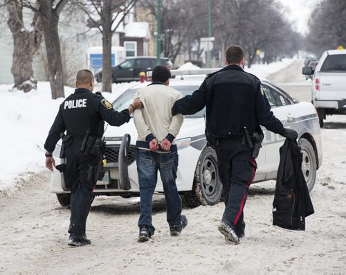 DAVID LIPNOWSKI / WINNIPEG FREE PRESS 160206  A man is taken into police custody after getting into an altercation at the scene of an unrelated crime Saturday February 6, 2015 in the 500 block of Stella Avenue.