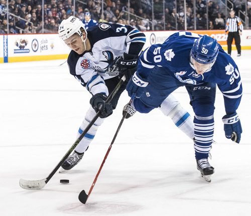 DAVID LIPNOWSKI / WINNIPEG FREE PRESS 160206  Manitoba Moose #34 JC Lipon gets tangled up with Toronto Marlies #50 Viktor Loov Saturday February 6, 2015 at MTS Centre.