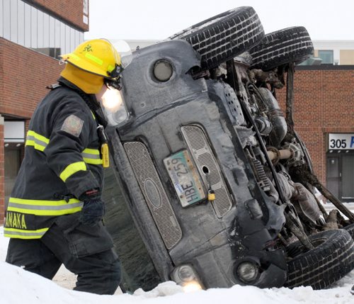 The driver of this SUV was lucky not to be seriously injured after flipping the vehicle on a large snowbank on Route 90 near Ellice ave monday-Breaking News- Feb 08, 2016   (JOE BRYKSA / WINNIPEG FREE PRESS)