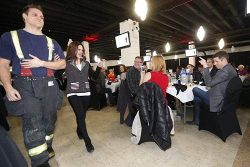 February 8, 2016 - 160208  -  Mayor Brian Bowman jokes around and let's his wife Tracy know that he has his eye on her as she struts along the runway with firefighter Mike Ogilvie at the SMD Foundation Attire to Aspire fashion show fundraiser at the Assiniboia Downs Monday, February 8, 2016.  John Woods / Winnipeg Free Press