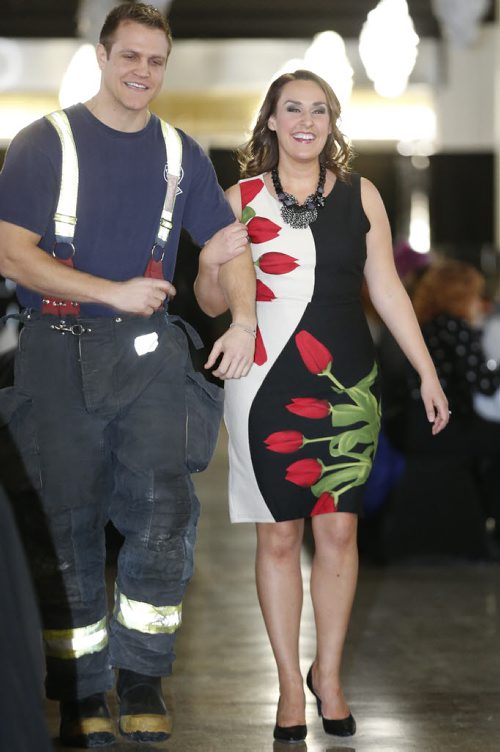 February 8, 2016 - 160208  -  TV personality Heather Steele struts along the runway with firefighter Mike Ogilvie at the SMD Foundation Attire to Aspire fashion show fundraiser at the Assiniboia Downs Monday, February 8, 2016.  John Woods / Winnipeg Free Press