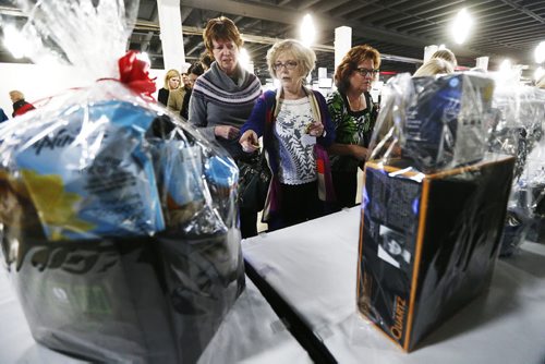 February 8, 2016 - 160208  -  Supporters take part in an auction at the SMD Foundation Attire to Aspire fashion show fundraiser at the Assiniboia Downs Monday, February 8, 2016.  John Woods / Winnipeg Free Press