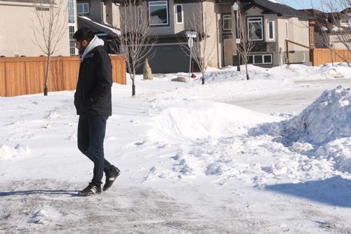 Sunny Brar who lives at 248 Southview Crescent and walks by snow bank that is blocking access to their street in one direction-See Bill Redekop story- Feb 09, 2016   (JOE BRYKSA / WINNIPEG FREE PRESS)