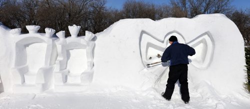 Snow sculptor Ralph Tanchak works on a snow angel beside the thrones he carved into a  snow wall in the children's activity area in Voyageur Park Tuesday afternoon for the upcoming Festival du Voyageur that runs Feb.12-21.Wayne Glowacki / Winnipeg Free Press Feb.9 2016