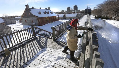Volunteer Yves Chartrand helps clear snow in Fort Gibraltar in Voyageur Park Tuesday afternoon for the upcoming Festival du Voyageur that runs Feb.12-21.Wayne Glowacki / Winnipeg Free Press Feb.9 2016