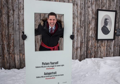 Mike Deal / Winnipeg Free Press Officials were invited to check out the grounds of the Festival du Voyageur the day before it's official opening and to have a look at the outdoor exhibition curated by the CMHR, Let Them Howl: 100 Years in the Women's Rights Struggle. Winnipeg Mayor Brian Bowman hams it up in the special frame set up outside of Fort Gibraltar as part of the CMHR exhibit. 160211 - Thursday, February 11, 2016