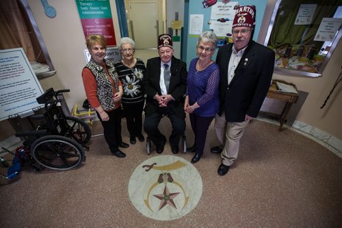 Mike Deal / Winnipeg Free Press A tour of the Rehabilitation Centre for Children on Wellington Crescent which is moving to a new location this coming spring.  From left: Darlene Borowski, Arla Sidebottom, Tom Sidebottom, Marge Wright and Don Thomson in the front lobby area of the Centre where the Shriners crest can still be found in the original terazzo floor. 160211 - Thursday, February 11, 2016