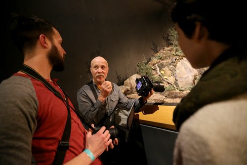 Dave Benson, middle, gives photography tips to Sam Giesbrecht, left, and Darcee Lytwyn during Safari Night at the Manitoba Museum, where people were taking guided tours with photography tips, Thursday, February 11, 2016. (TREVOR HAGAN/WINNIPEG FREE PRESS)