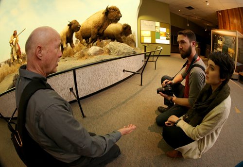 Dave Benson gives photography tips to Sam Giesbrecht and Darcee Lytwyn during Safari Night at the Manitoba Museum, where people were taking guided tours with photography tips, Thursday, February 11, 2016. (TREVOR HAGAN/WINNIPEG FREE PRESS)
