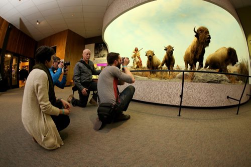 Dave Benson gives photography tips to Sam Giesbrecht and Darcee Lytwyn during Safari Night at the Manitoba Museum, where people were taking guided tours with photography tips, Thursday, February 11, 2016. (TREVOR HAGAN/WINNIPEG FREE PRESS)