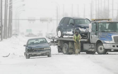 John Woods / Winnipeg Free Press / February 17, 2008 - 080217 - Crews clean up after a three car collision on Waverley just south of Bison Sunday February 17, 2008.