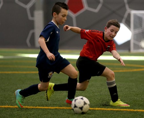 In Under 11 Developmental soccer at the Golden Boy Indoor Soccer Tournament, Bonivital Jax Chammartin left, carries the ball in front of South End United's Nicolas Scarpino during their game at the University of Winnipeg, Saturday, February 13, 2016. (TREVOR HAGAN/WINNIPEG FREE PRESS)