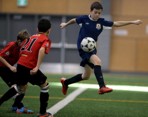 In Under 11 Developmental soccer at the Golden Boy Indoor Soccer Tournament, a player from Bonivital carries the ball versus South End United during their game at the University of Winnipeg, Saturday, February 13, 2016. (TREVOR HAGAN/WINNIPEG FREE PRESS)