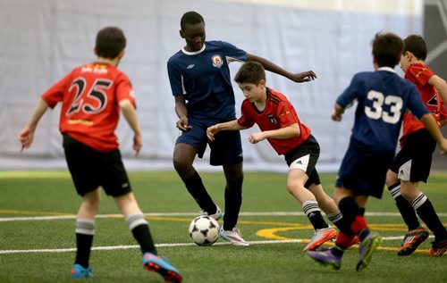 In Under 11 Developmental soccer at the Golden Boy Indoor Soccer Tournament, a player from Bonivital carries the ball versus South End United during their game at the University of Winnipeg, Saturday, February 13, 2016. (TREVOR HAGAN/WINNIPEG FREE PRESS)